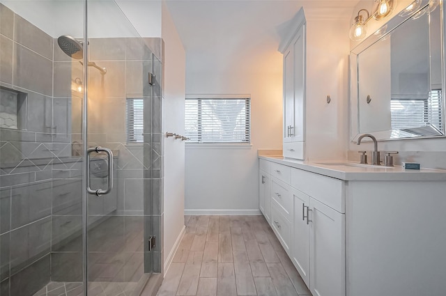 full bathroom featuring a shower stall, wood finished floors, and vanity