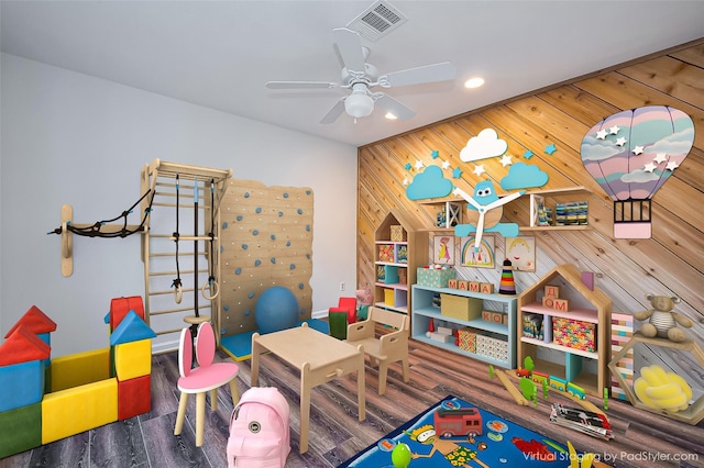 rec room with visible vents, ceiling fan, wood walls, recessed lighting, and wood finished floors