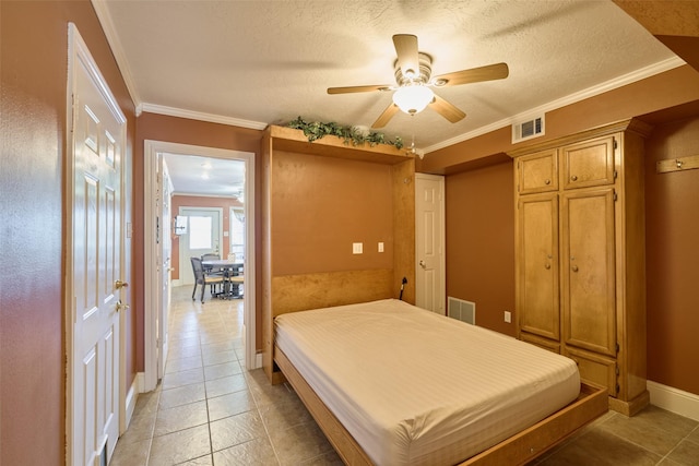 bedroom featuring visible vents, baseboards, ornamental molding, and light tile patterned flooring