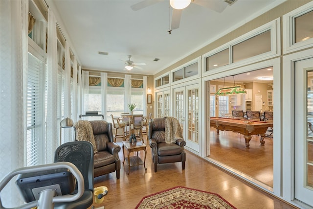 sunroom featuring a ceiling fan, french doors, and visible vents