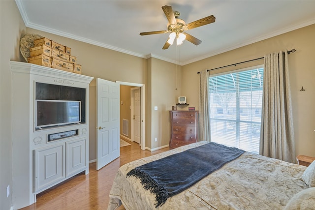 bedroom with visible vents, a ceiling fan, wood finished floors, and crown molding