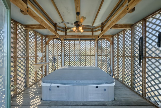 wooden deck with ceiling fan and a hot tub