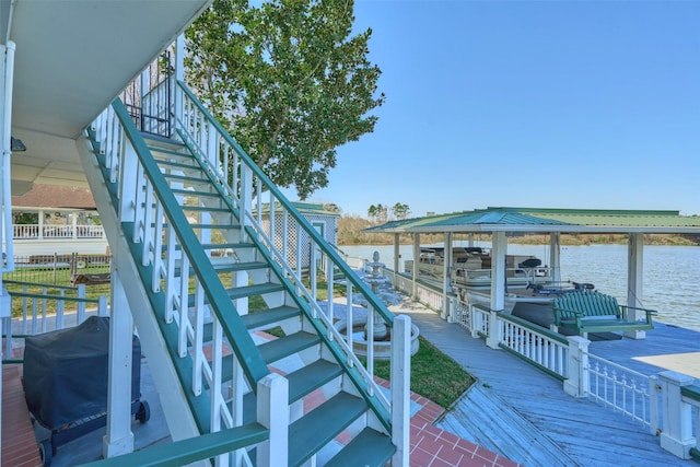 exterior space featuring stairway and a water view