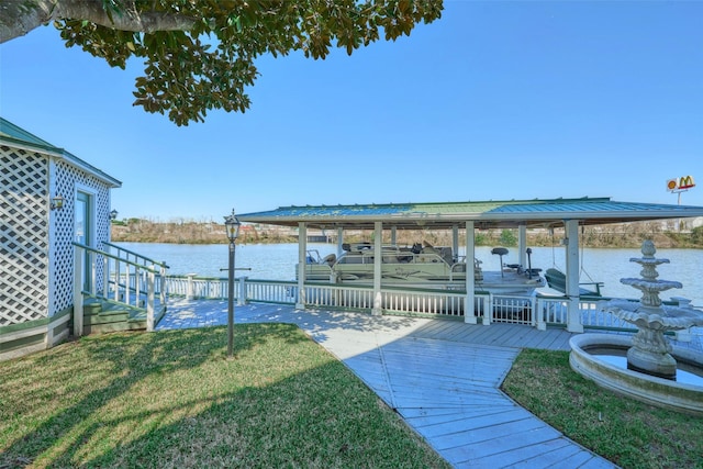 view of yard with a water view and a boat dock