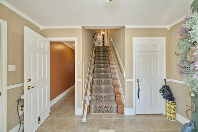 staircase featuring tile patterned flooring, visible vents, crown molding, and baseboards