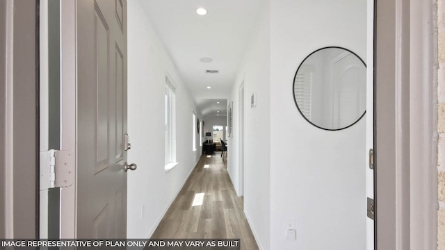 hallway with light wood-style floors and recessed lighting