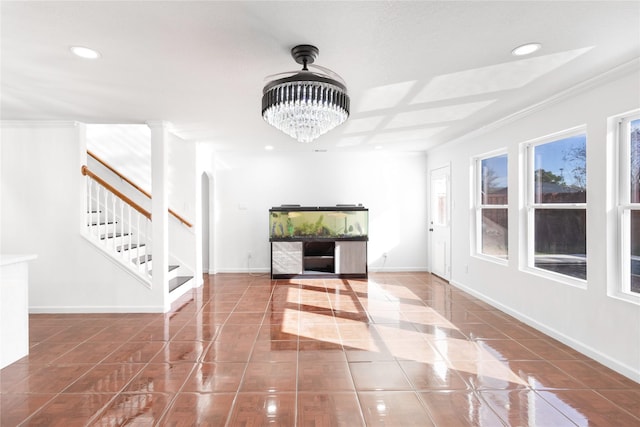 entryway with stairs, arched walkways, recessed lighting, baseboards, and tile patterned floors