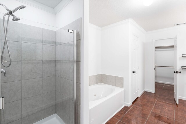 bathroom featuring a bath, a stall shower, visible vents, and crown molding