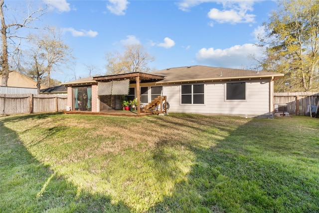 back of house with a lawn and a fenced backyard