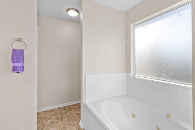 bathroom with baseboards and a jetted tub