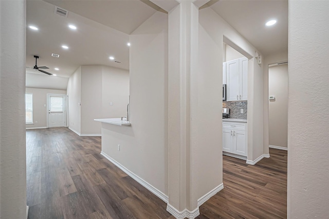 hall with dark wood-style floors, recessed lighting, and baseboards