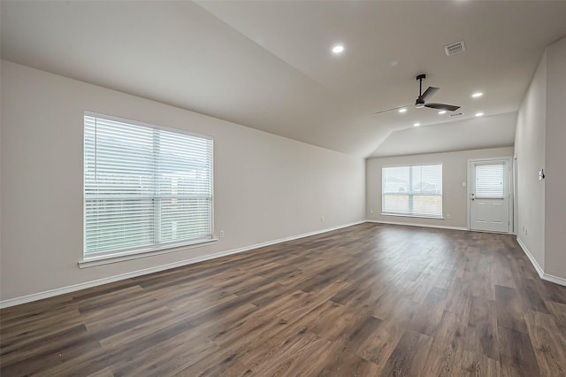 spare room with dark wood-style floors, lofted ceiling, recessed lighting, visible vents, and baseboards