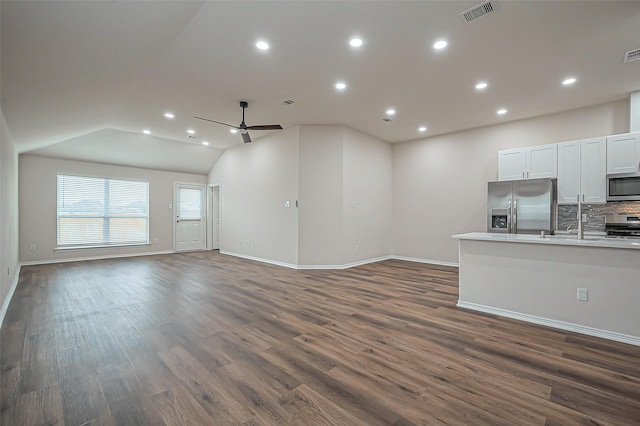 unfurnished living room featuring visible vents, a ceiling fan, dark wood-style flooring, vaulted ceiling, and recessed lighting