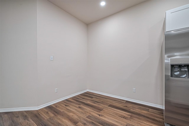 unfurnished room featuring recessed lighting, dark wood-style flooring, and baseboards