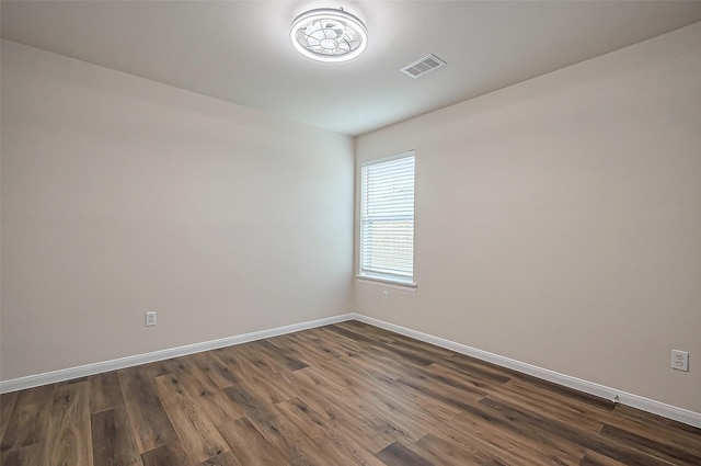 19430 Mystic Cypress Dr, Katy, TX 77449 - unfurnished room featuring baseboards, visible vents, and dark wood-type flooring
