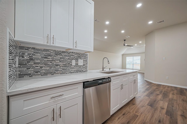 kitchen with dark wood finished floors, visible vents, stainless steel dishwasher, white cabinetry, and a sink