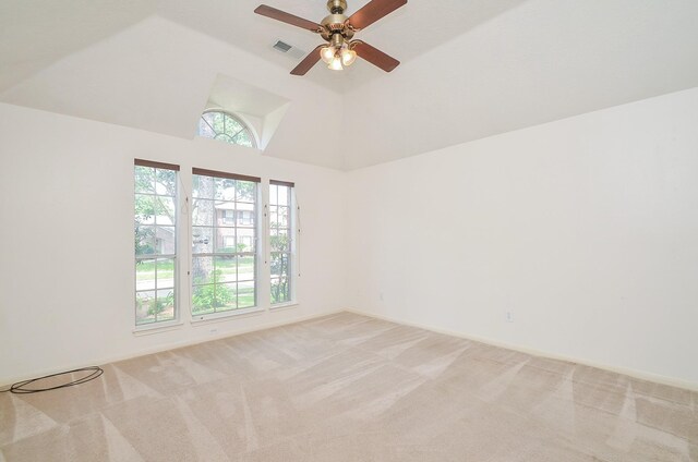 empty room with light carpet, lofted ceiling, visible vents, and a ceiling fan