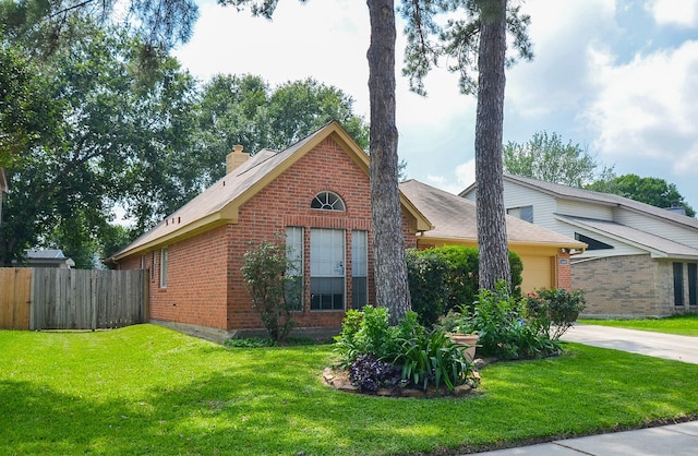 view of home's exterior with brick siding, a yard, concrete driveway, fence, and a garage