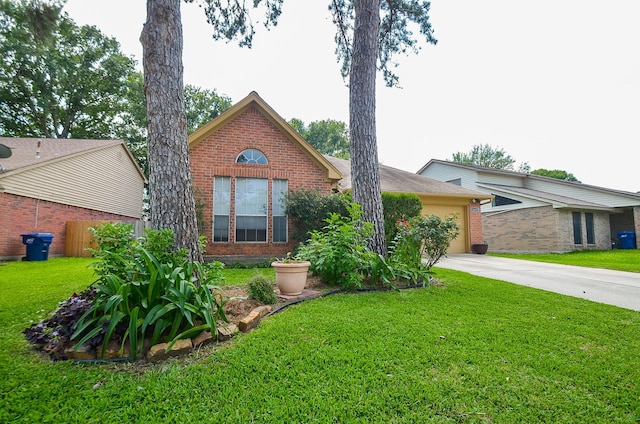 view of front facade featuring a front yard, concrete driveway, and brick siding