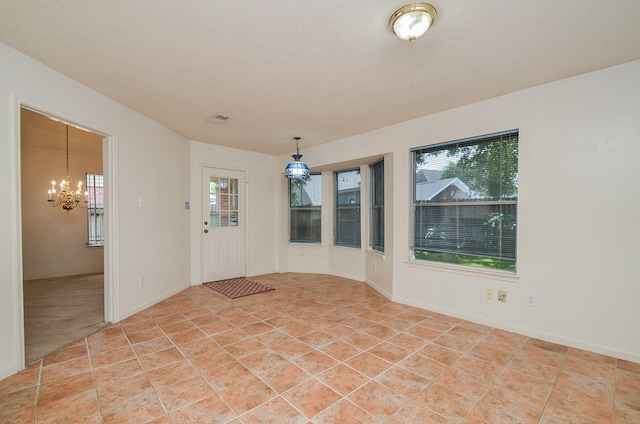 foyer featuring a healthy amount of sunlight and light tile patterned floors