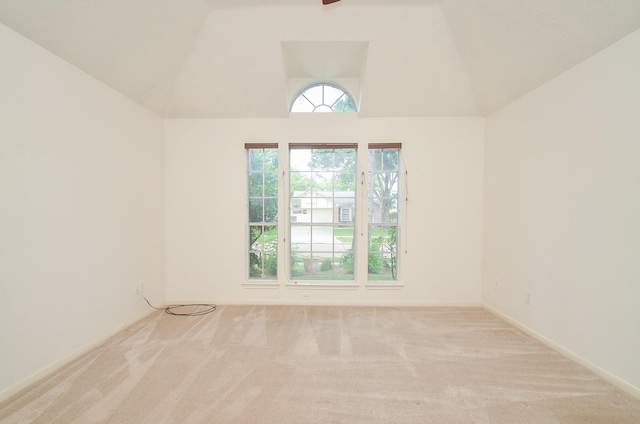 empty room featuring lofted ceiling and carpet flooring