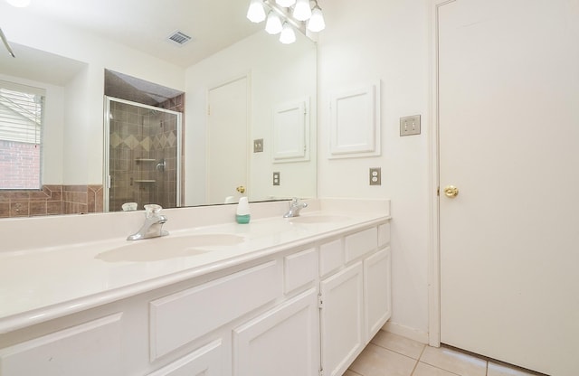 full bathroom with visible vents, a sink, a shower stall, and tile patterned floors