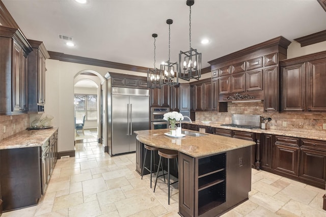 kitchen featuring visible vents, open shelves, arched walkways, stone tile flooring, and appliances with stainless steel finishes