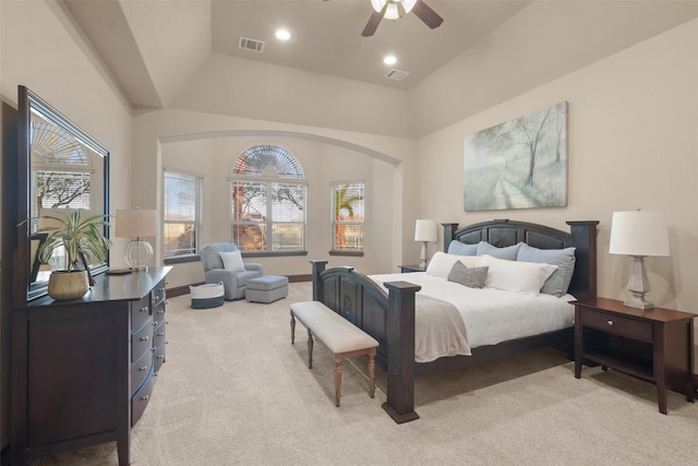 bedroom featuring baseboards, visible vents, recessed lighting, arched walkways, and light colored carpet