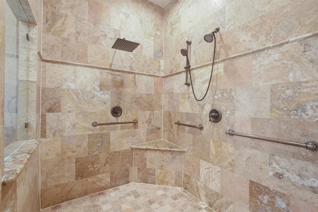 full bath with a tile shower