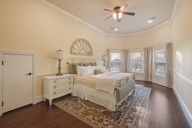 bedroom featuring visible vents, baseboards, dark wood finished floors, and ornamental molding