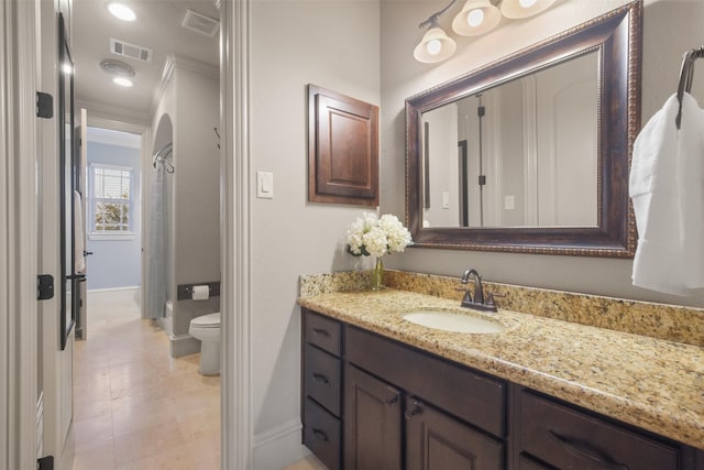 full bathroom featuring visible vents, toilet, ornamental molding, and vanity