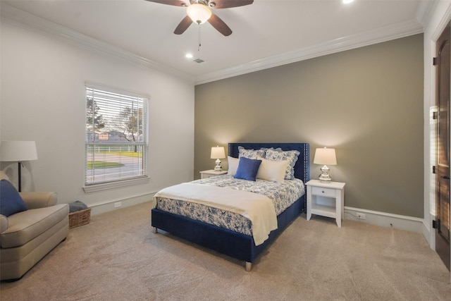 carpeted bedroom with visible vents, a ceiling fan, baseboards, and ornamental molding