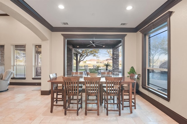 dining area featuring stone tile floors, visible vents, and crown molding