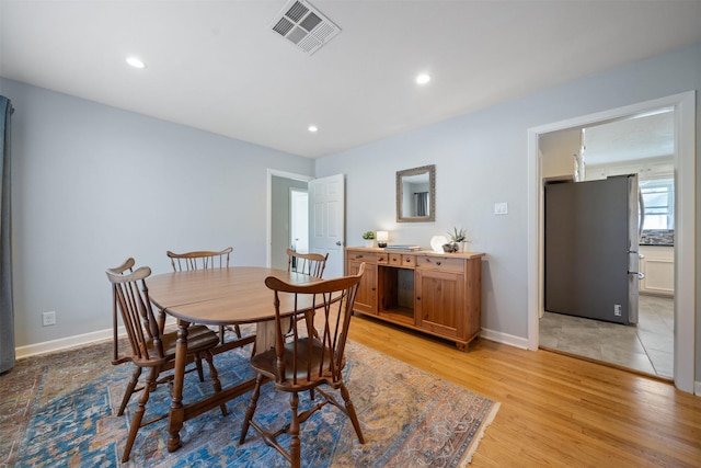 dining room with recessed lighting, visible vents, baseboards, and light wood-style flooring