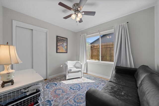 interior space with baseboards and ceiling fan