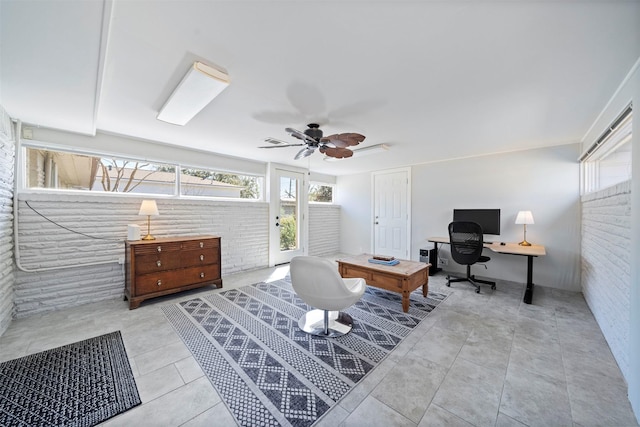 office space with tile patterned flooring, brick wall, and ceiling fan