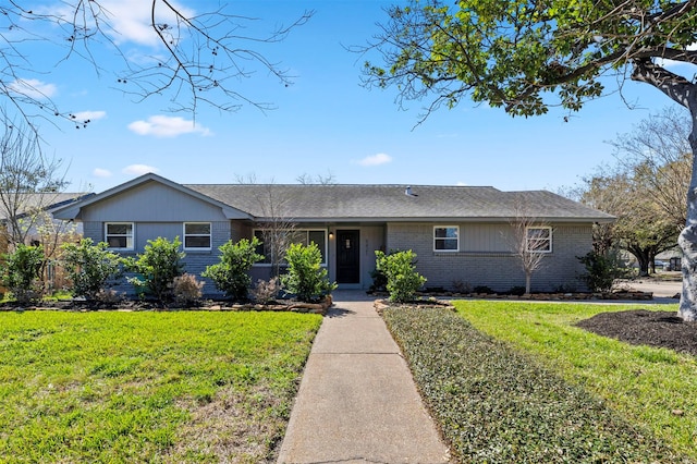 single story home with brick siding and a front lawn