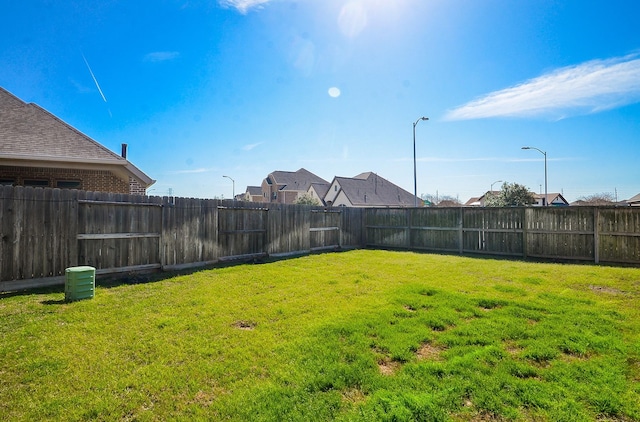 view of yard with a fenced backyard