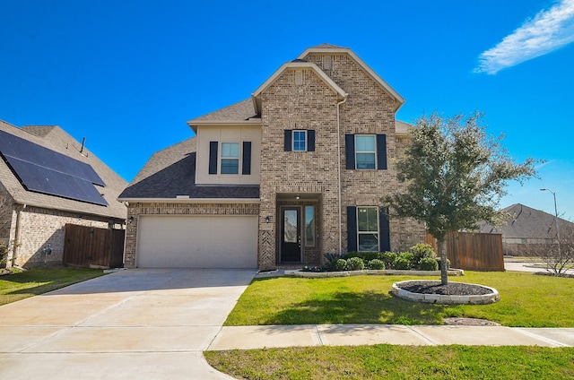 traditional-style home with concrete driveway, brick siding, a front lawn, and fence