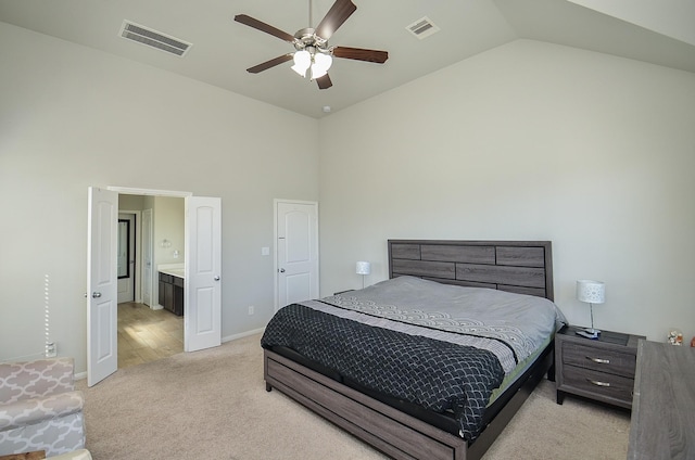 bedroom with high vaulted ceiling, visible vents, light carpet, and baseboards