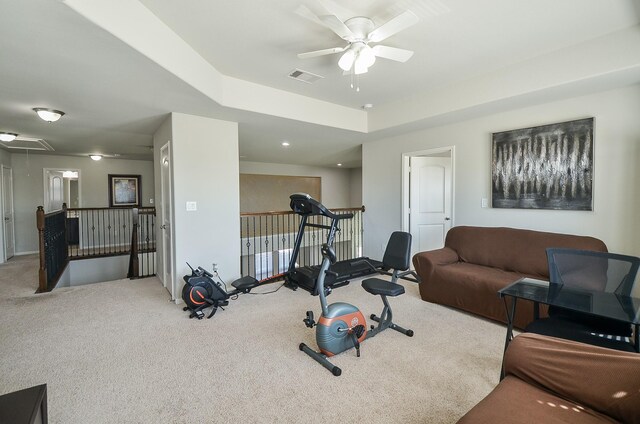 workout area featuring visible vents, carpet floors, attic access, and a ceiling fan