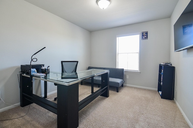 carpeted office space featuring baseboards