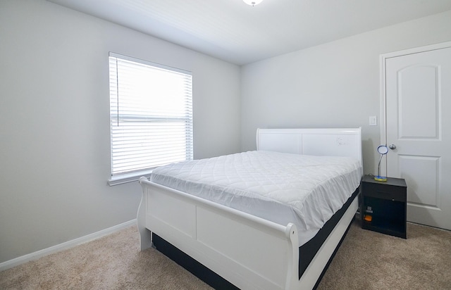 bedroom featuring carpet and baseboards