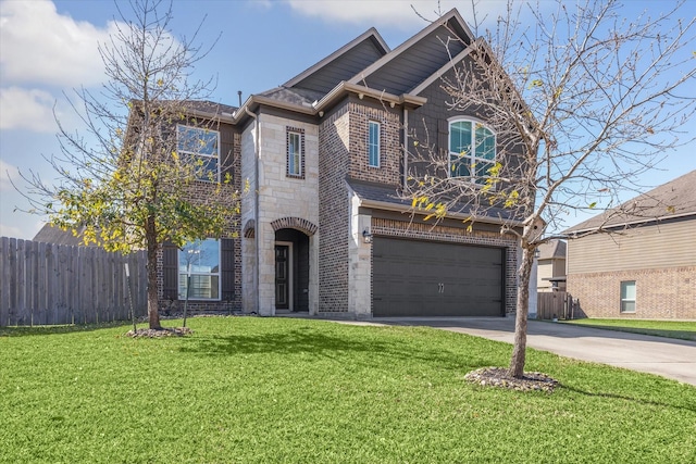 view of front of home featuring driveway, stone siding, fence, a front lawn, and brick siding