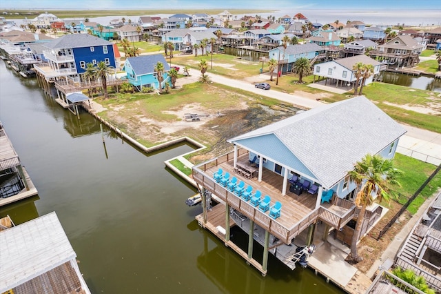 drone / aerial view with a residential view and a water view