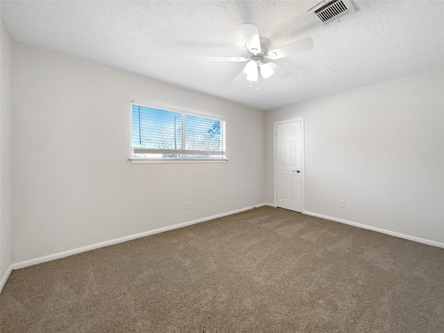 empty room featuring visible vents, a textured ceiling, carpet, baseboards, and ceiling fan