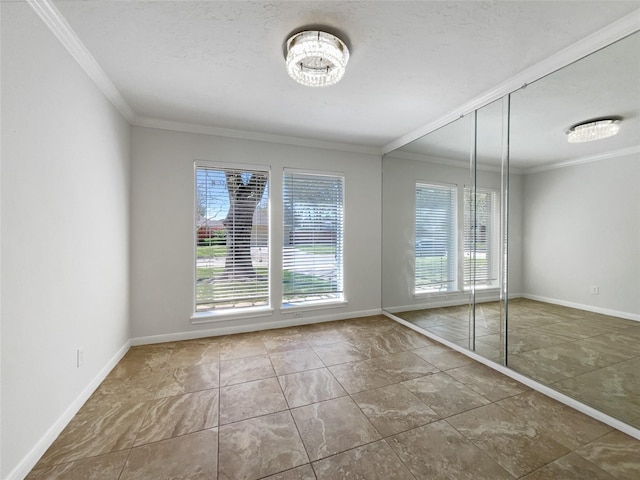 unfurnished room featuring a healthy amount of sunlight, baseboards, and ornamental molding