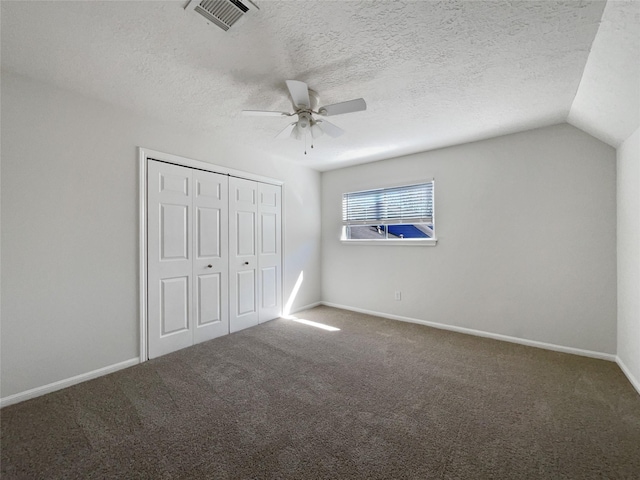 unfurnished bedroom with visible vents, a closet, carpet flooring, baseboards, and ceiling fan