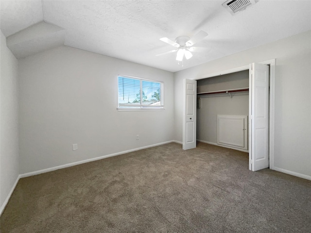 unfurnished bedroom featuring baseboards, visible vents, ceiling fan, a closet, and carpet flooring