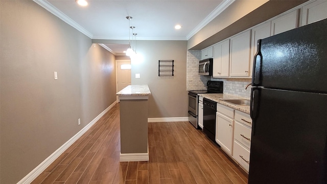 kitchen with decorative backsplash, a sink, black appliances, and wood finished floors